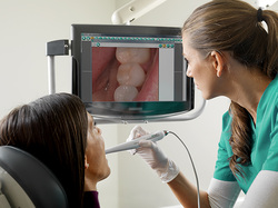 Picture of assistant taking an intraoral picture.